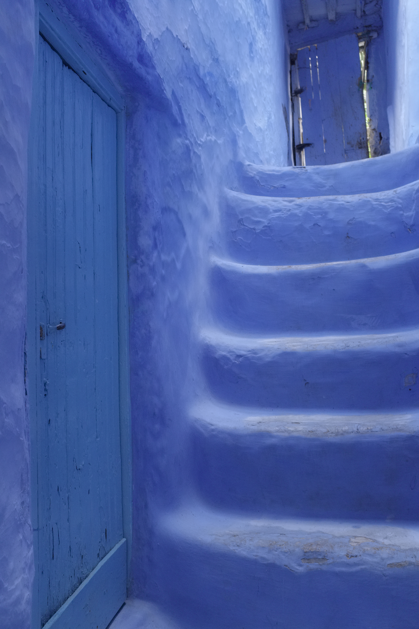 Photo of a blue door and blue stairs in Chefchaouen, Morocco, by Laurie Cohen.