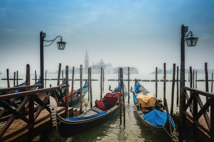 A photo of gondolas at rest in the early morning, near St. Mark's Square, Venice, Italy, by Roman Martin