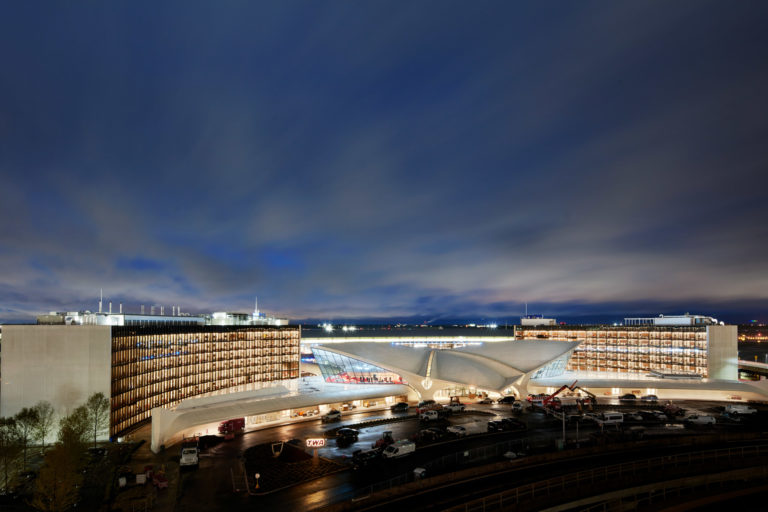 Photo of the TWA Hotel, at night, at JFK airport.